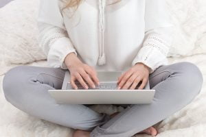 a woman blogging on her laptop